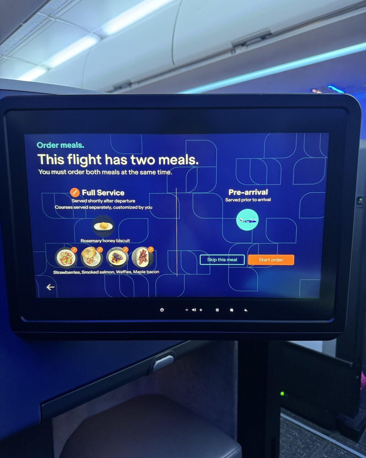 JetBlue Mint seatback screen showing the order-meals interface — full service after departure and a pre-arrival breakfast