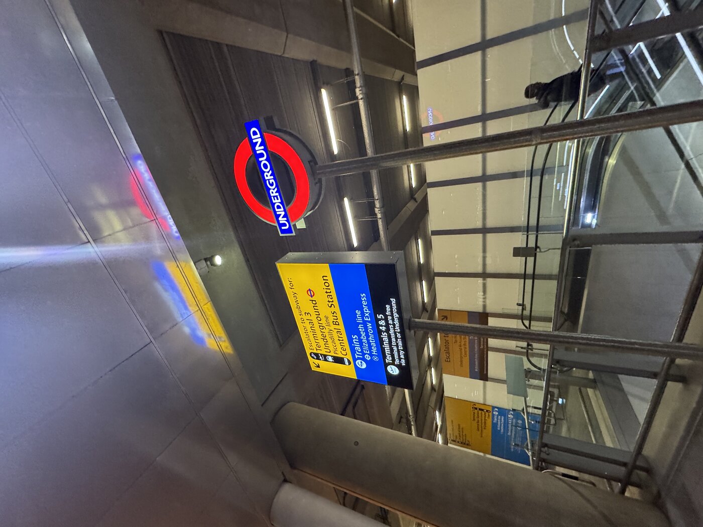 Heathrow rail signage pointing to the Underground Piccadilly line, Elizabeth line, and Heathrow Express